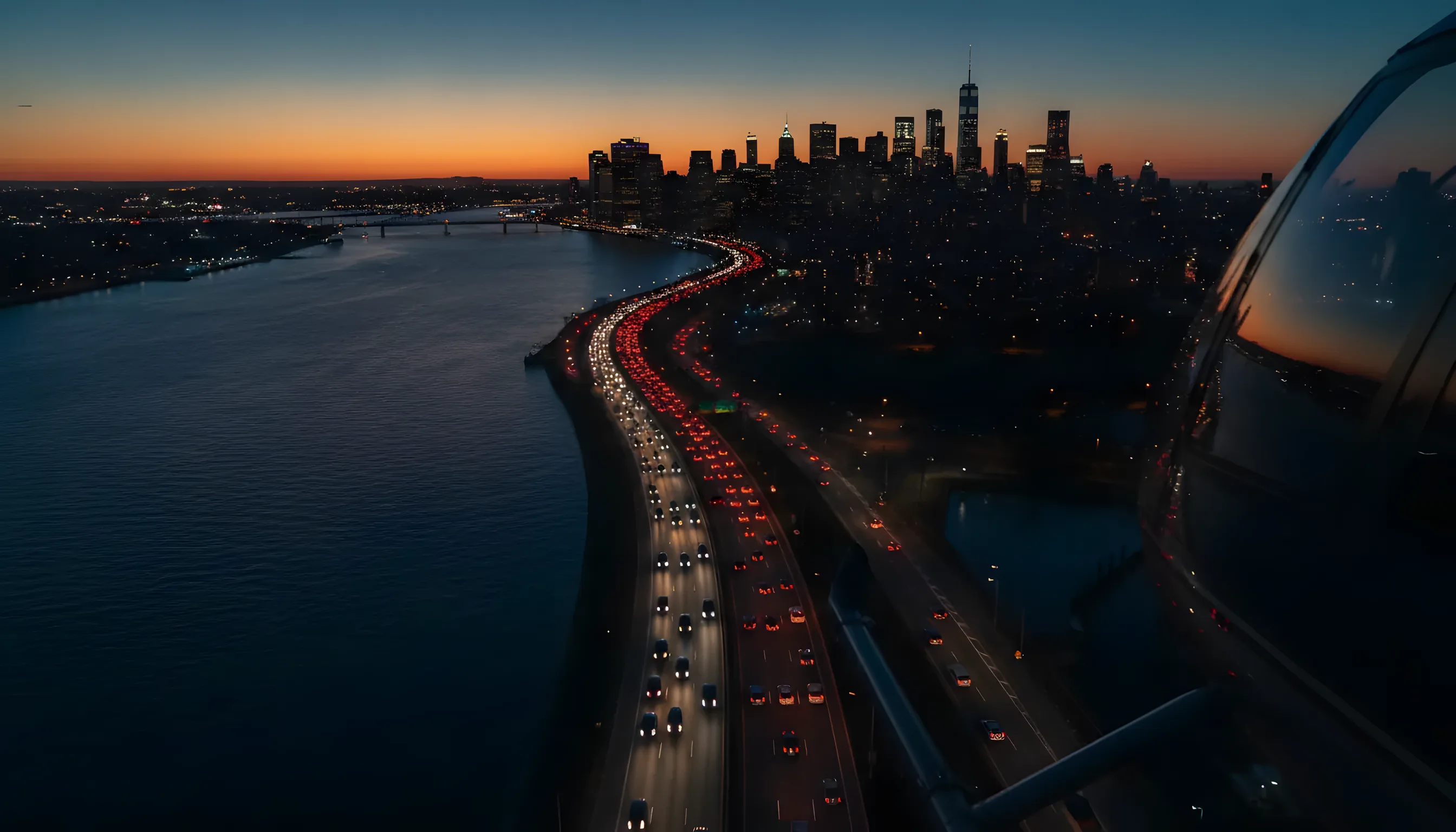 Aerial view of rush hour traffic leaving the Manhattan skyline for New Jersey at dusk.