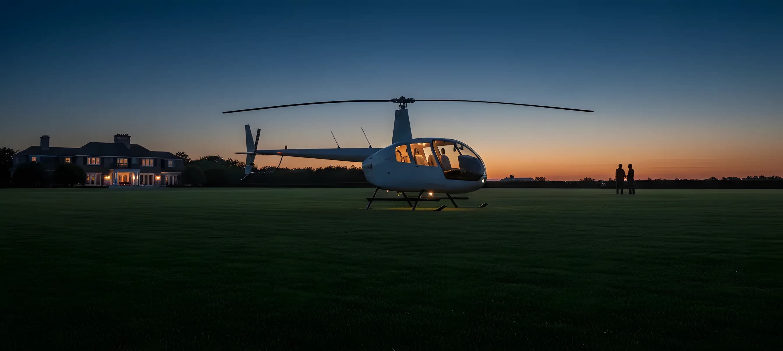 A white helicopter parked on a lush green lawn in the Hamptons on a sunny day.