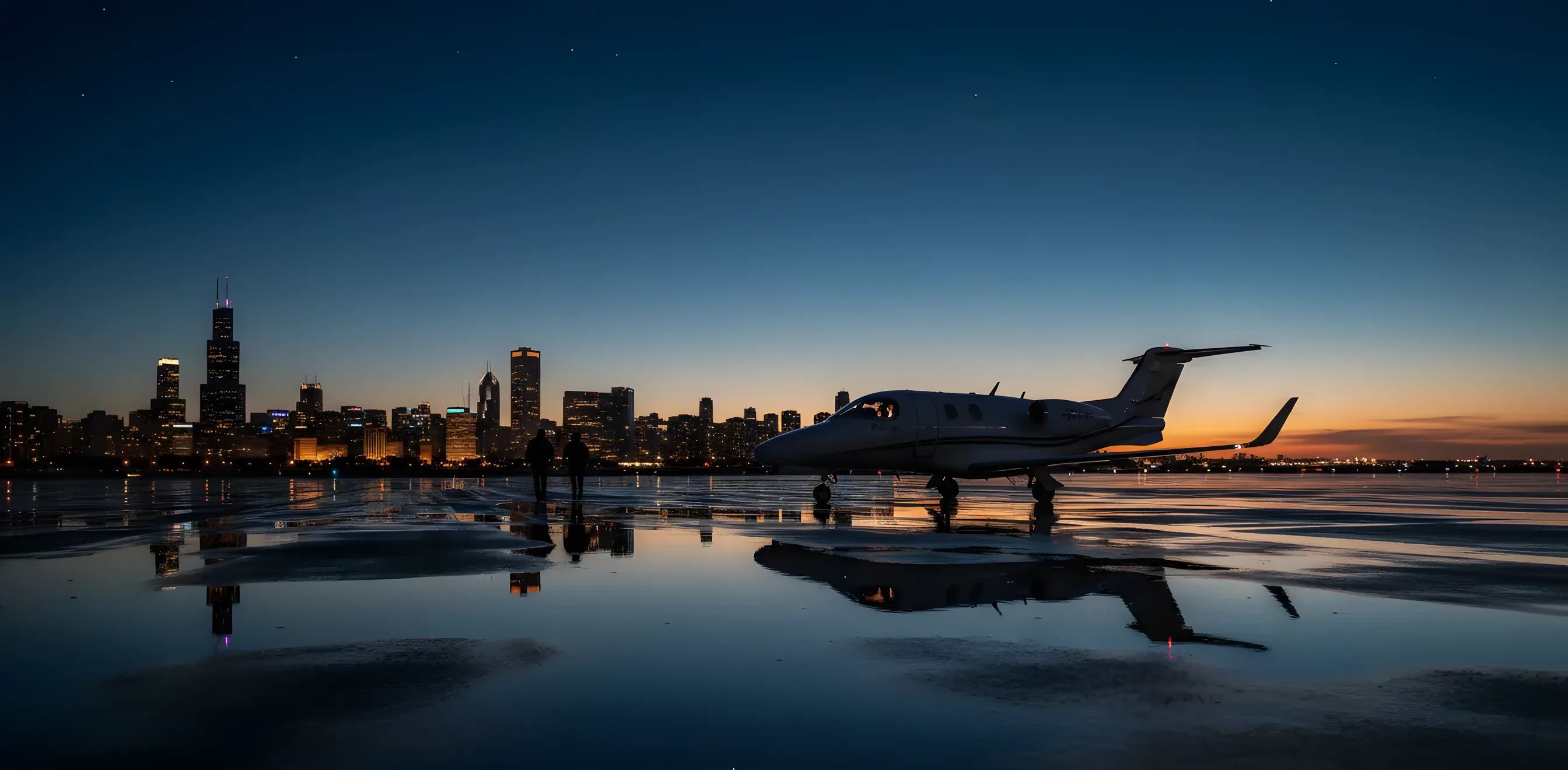 A small private jet on an airport tarmac at dusk, with a city skyline in the background.