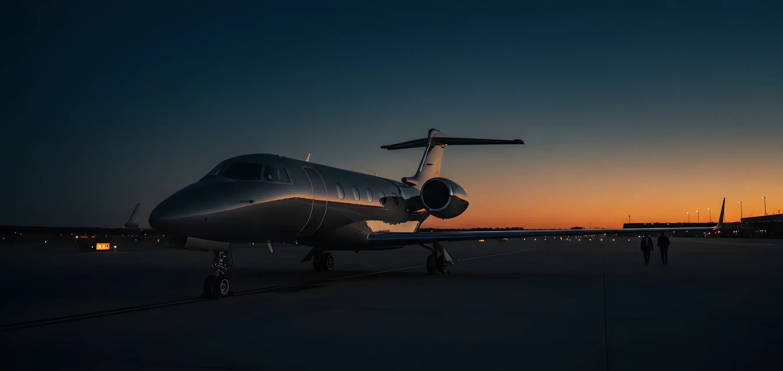 A private jet on an empty tarmac, its fuselage reflecting the warm glow of the setting sun.