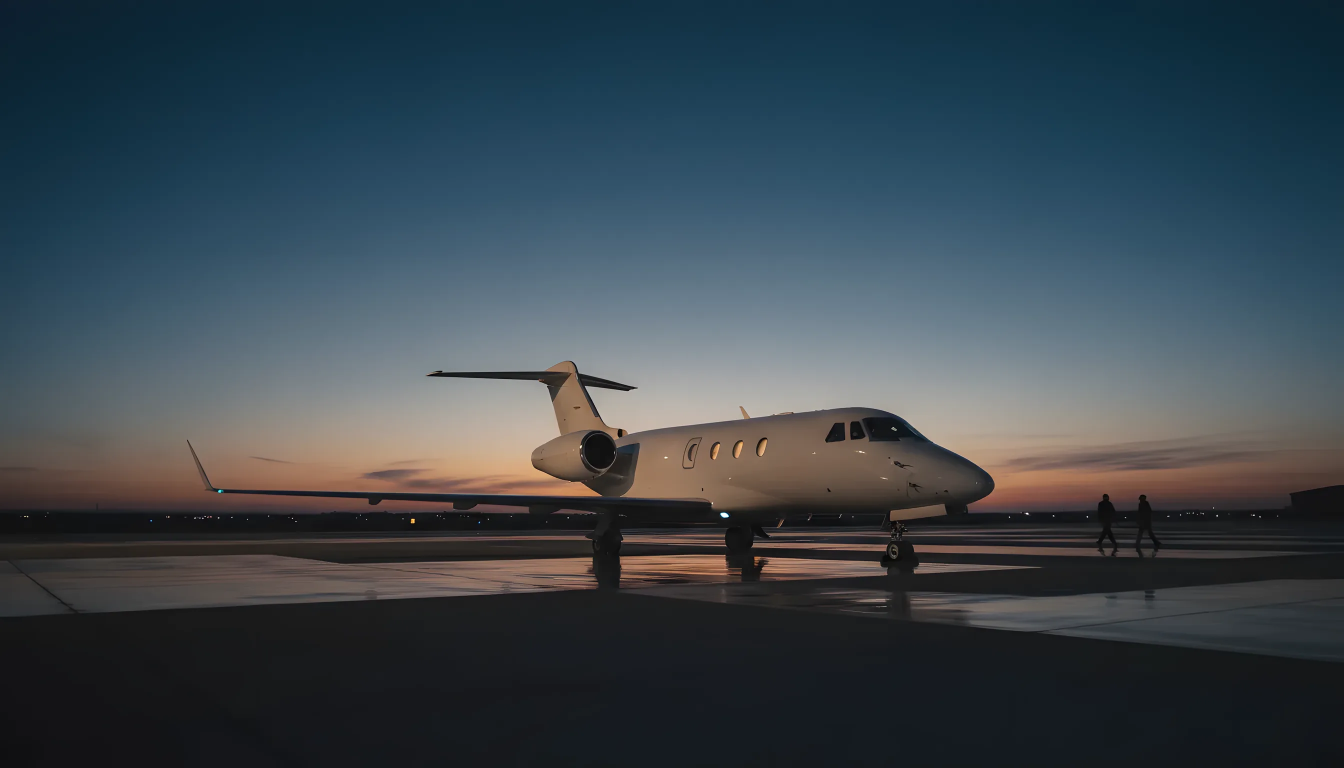 A sleek white private jet sits on a quiet tarmac in the early morning light.