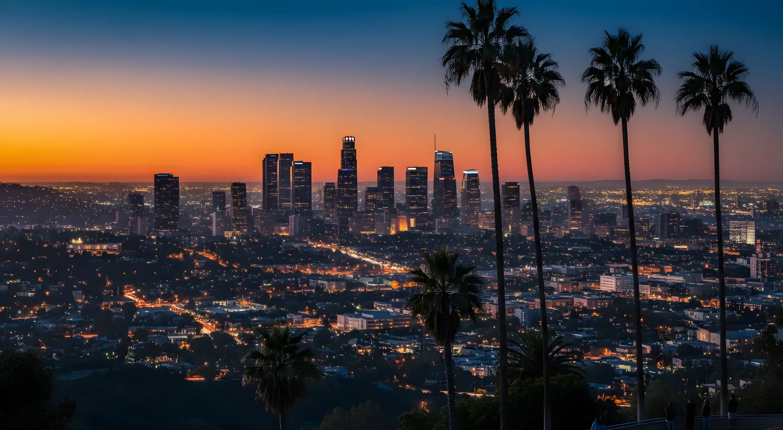 The downtown Los Angeles skyline at blue hour seen from the Griffith Park hills.