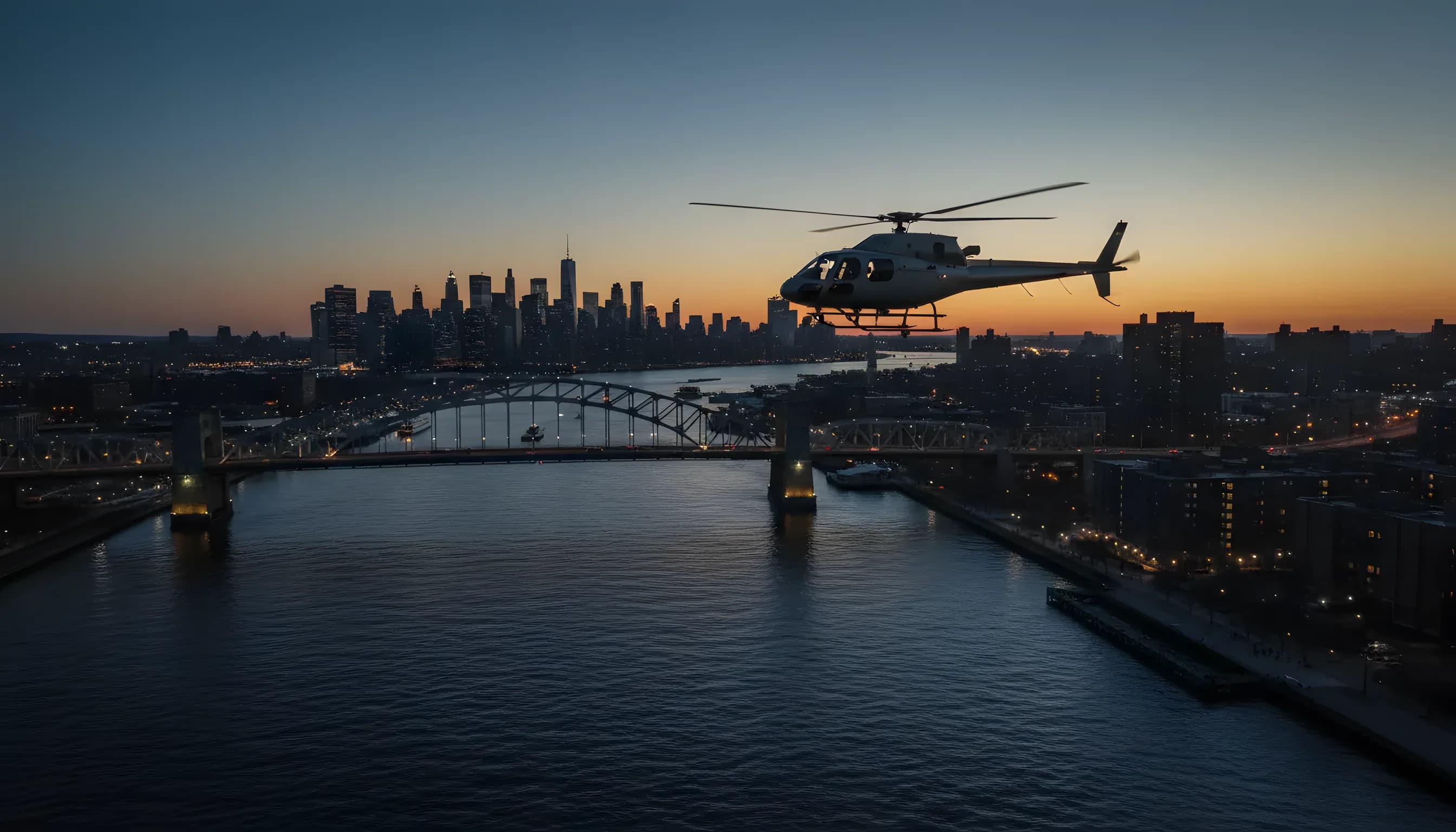 A helicopter flies over the East River at dusk, with the Hell Gate Bridge and Astoria, Queens in the background.