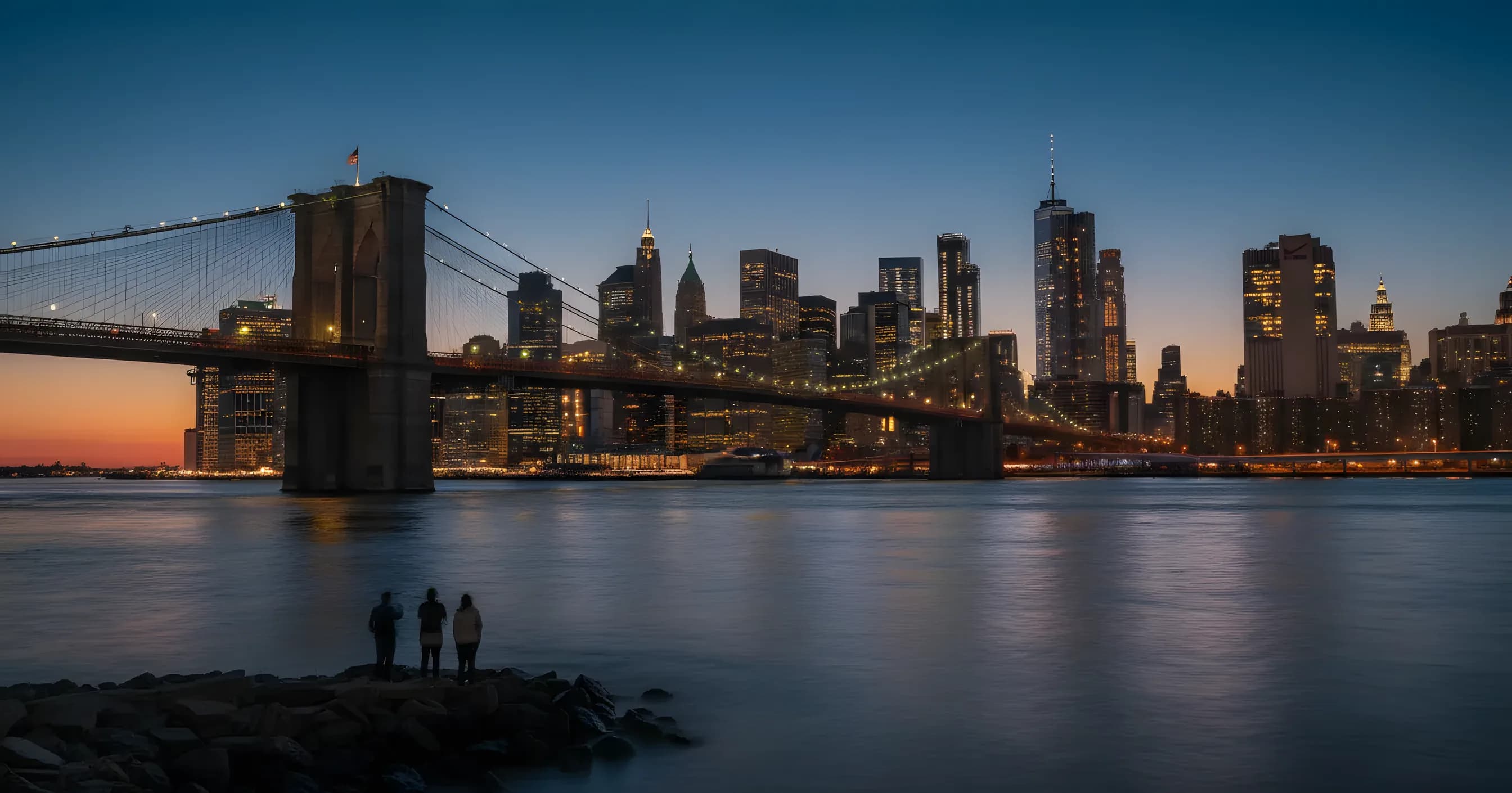 The Lower Manhattan skyline and Brooklyn Bridge seen from DUMBO, Brooklyn at dusk.