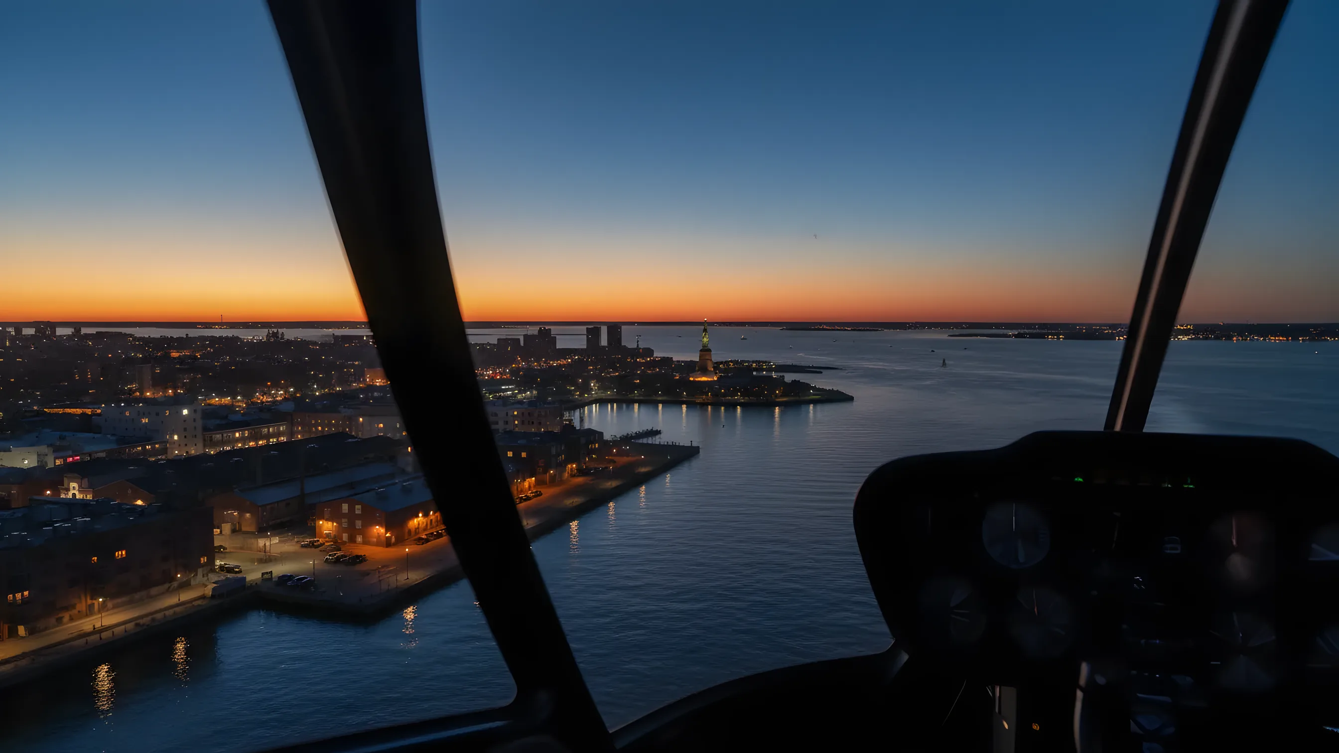 Aerial view of the Red Hook, Brooklyn waterfront and the Statue of Liberty at dusk.