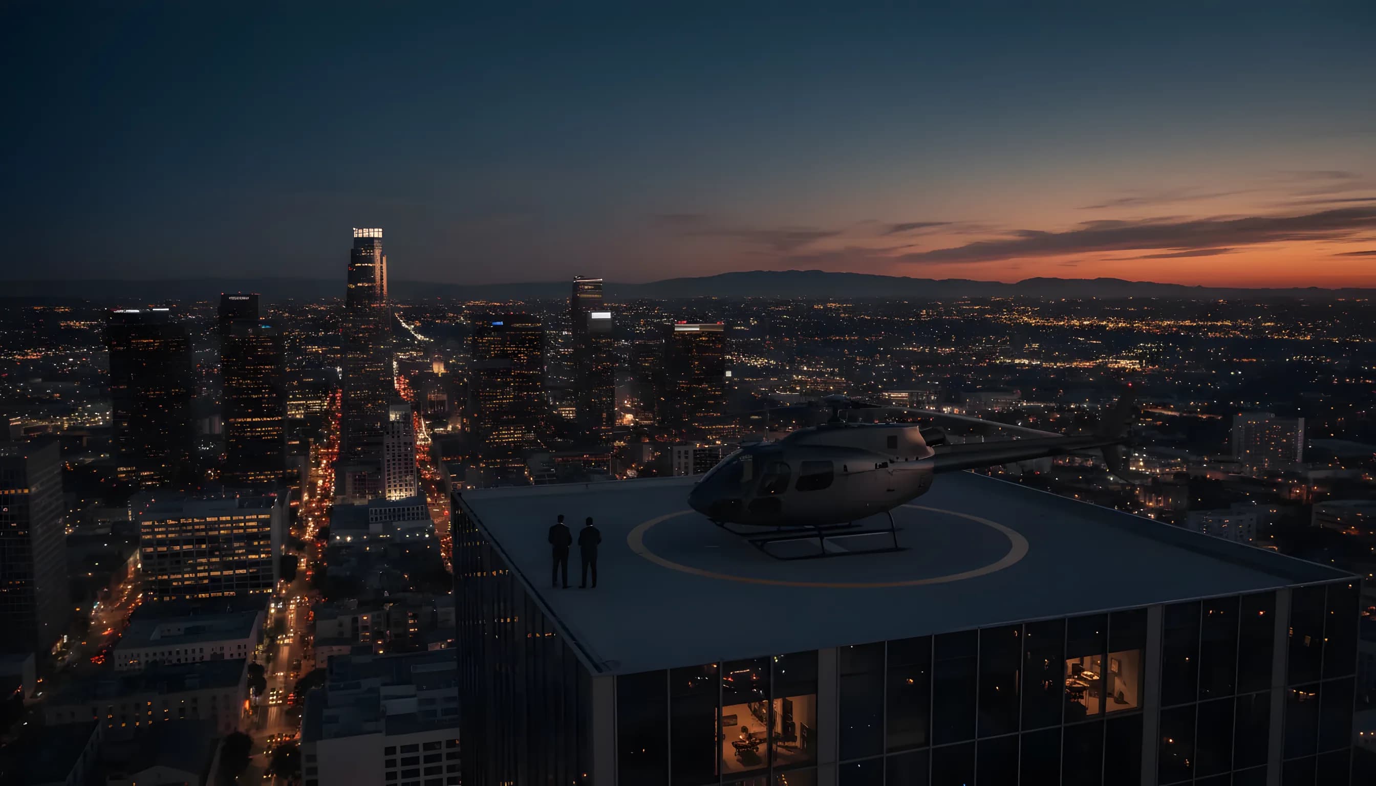 A helicopter on a skyscraper helipad at dusk, overlooking the glowing city lights of Los Angeles.