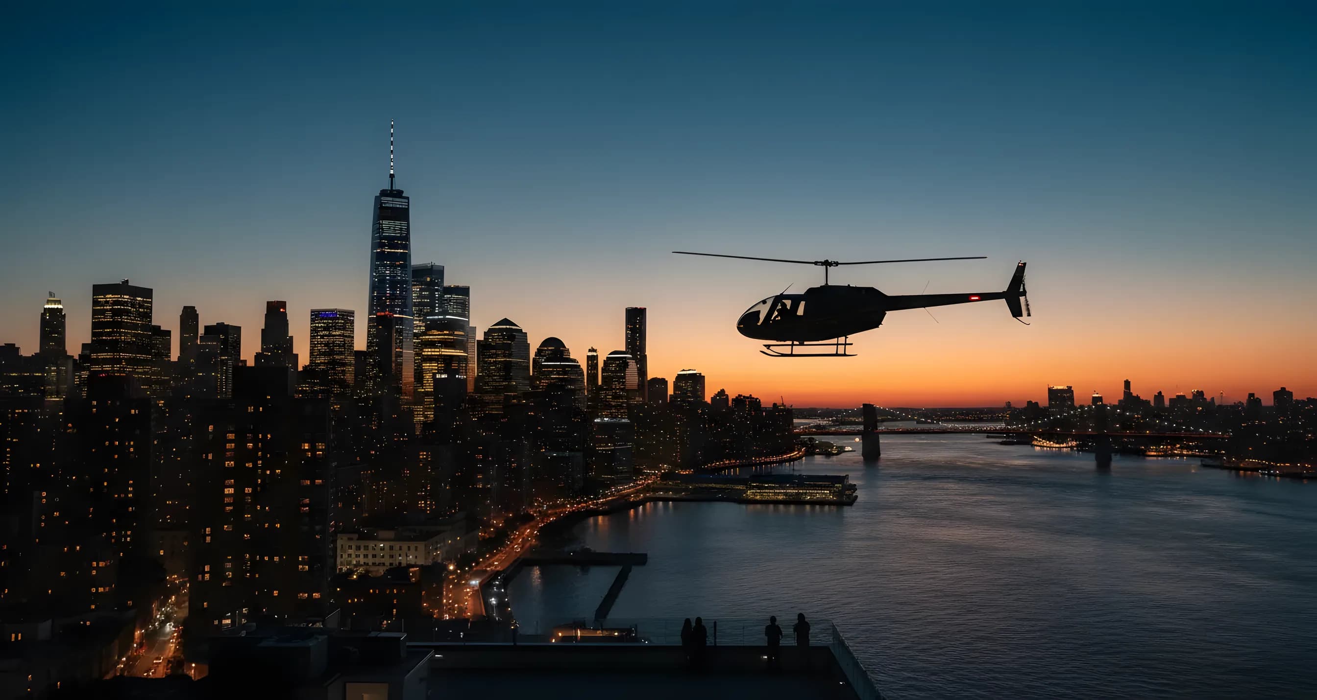 A helicopter flies over the glowing skyline of Lower Manhattan and the Hudson River just after sunset.