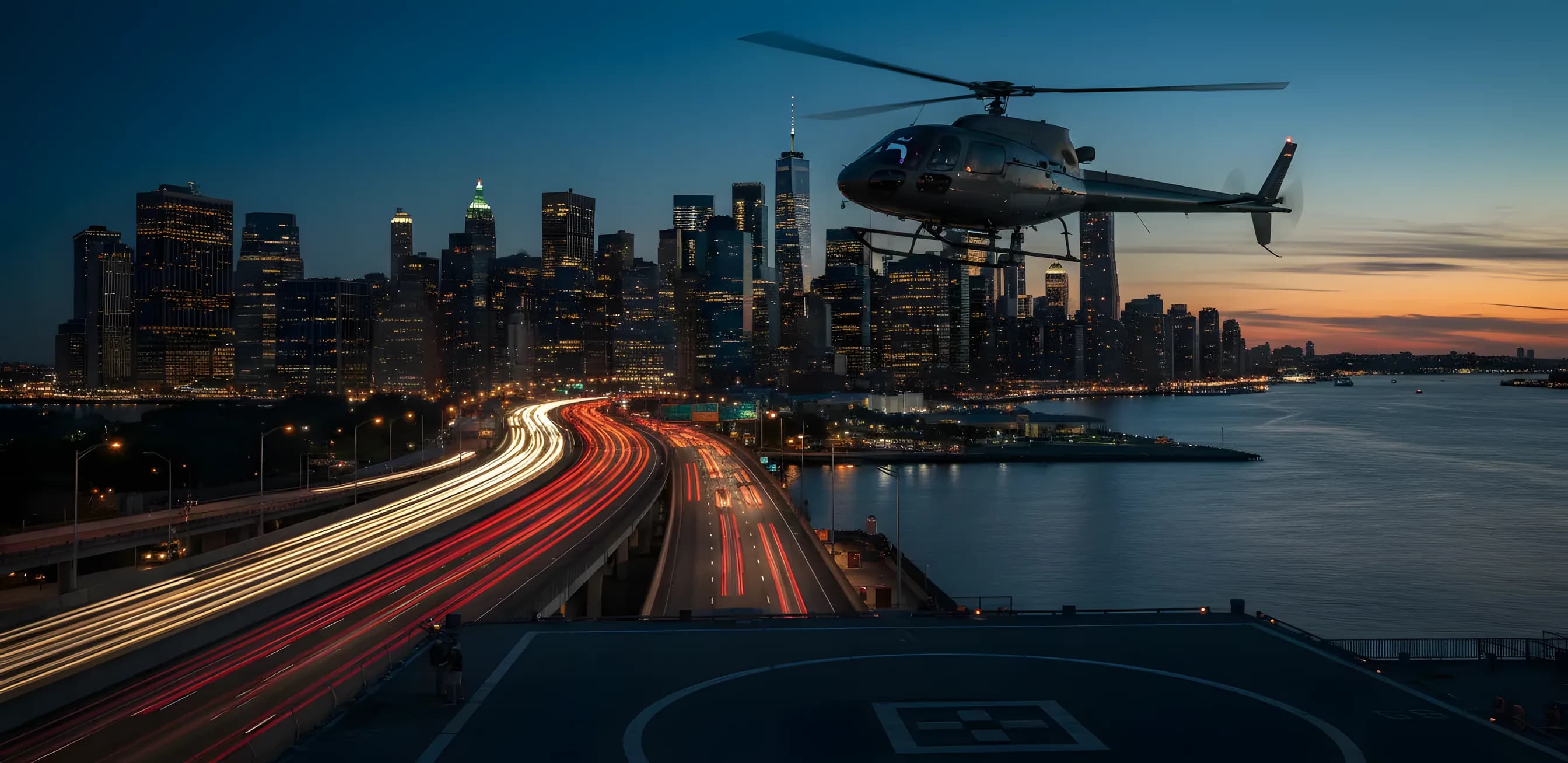 A helicopter takes off from a Manhattan heliport at dusk, with heavy traffic visible on the highway below.