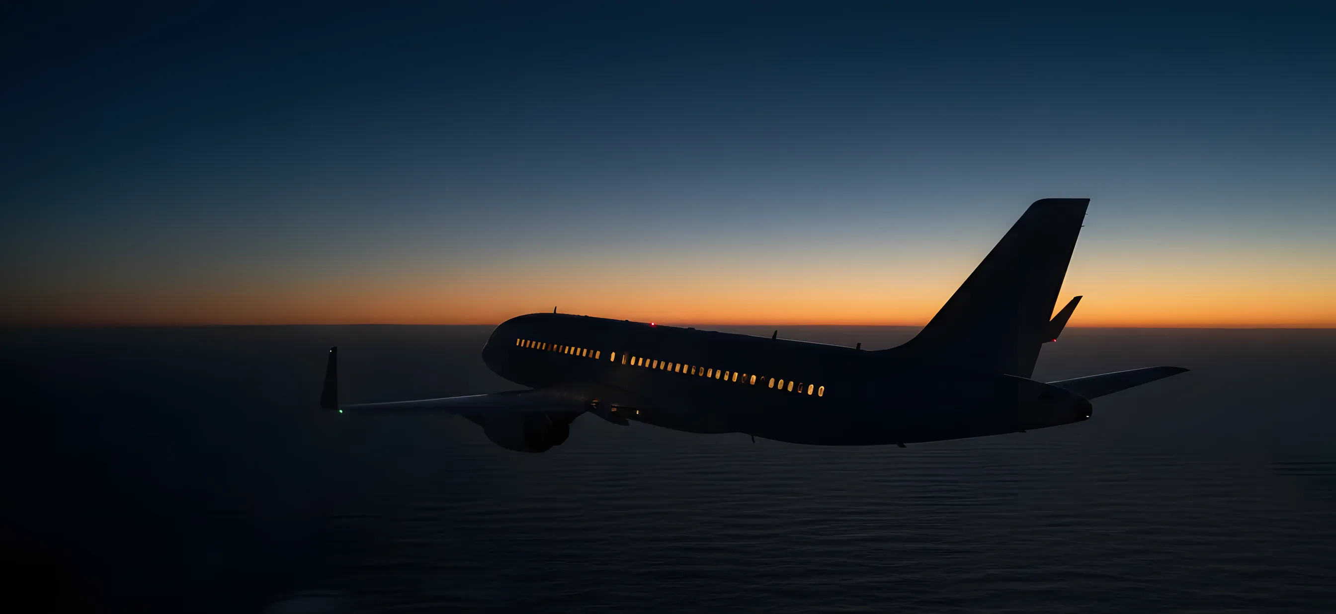 A passenger jet flies over the ocean at dusk, with the horizon glowing in the distance.