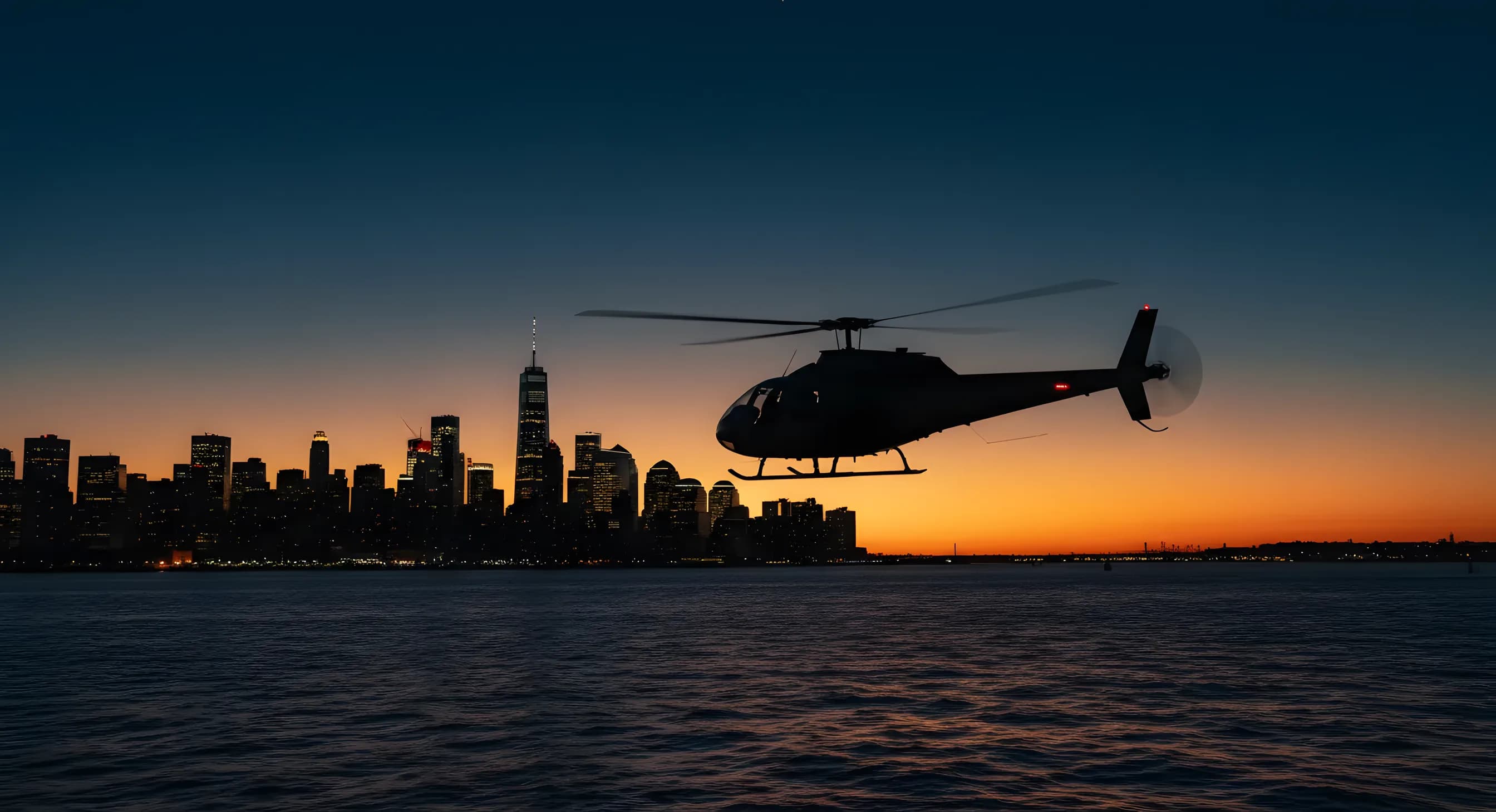 A helicopter flies over the water at dusk, with the New York City skyline in the background.