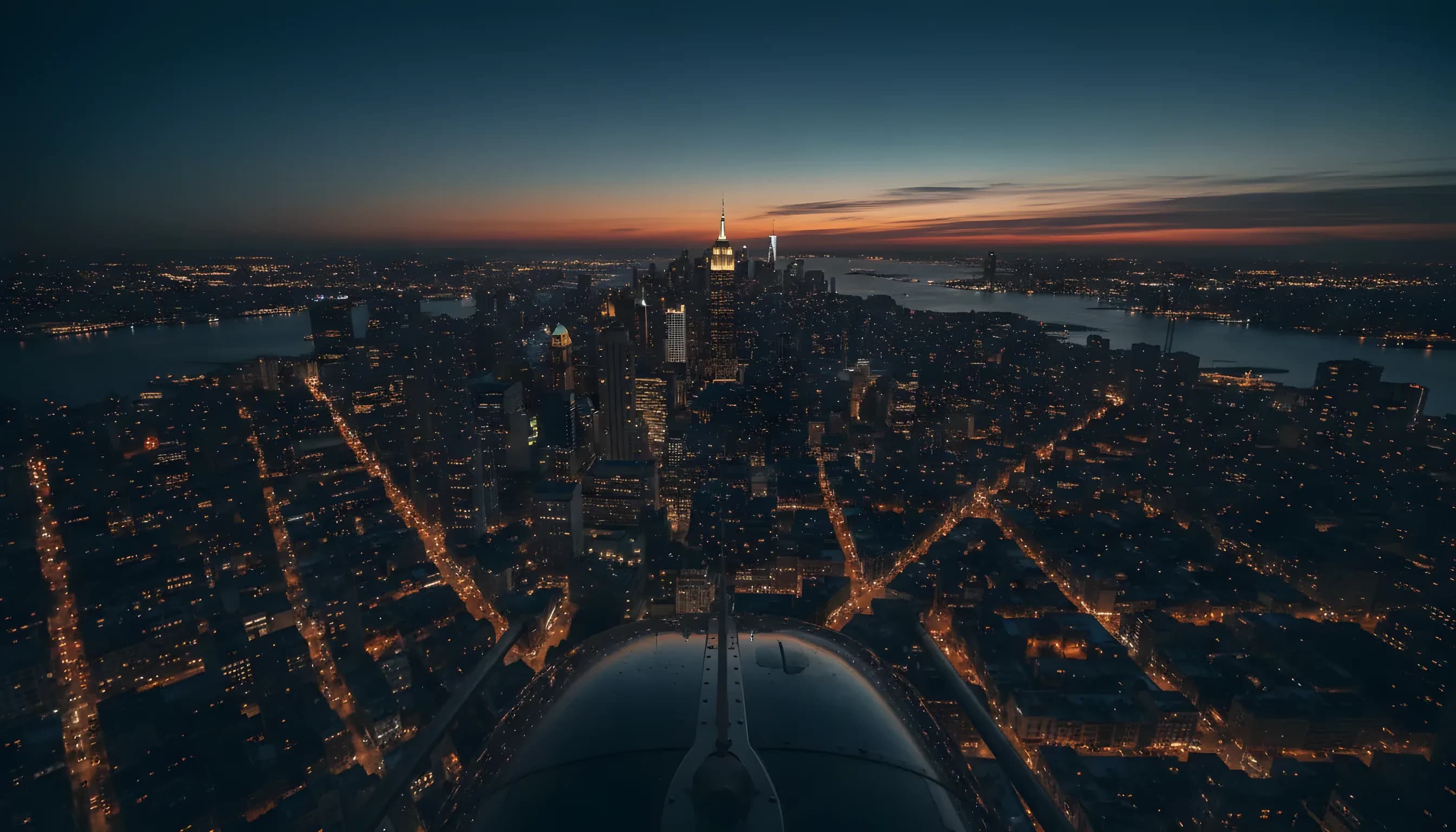 Aerial view of the Manhattan skyline at dusk from a helicopter.