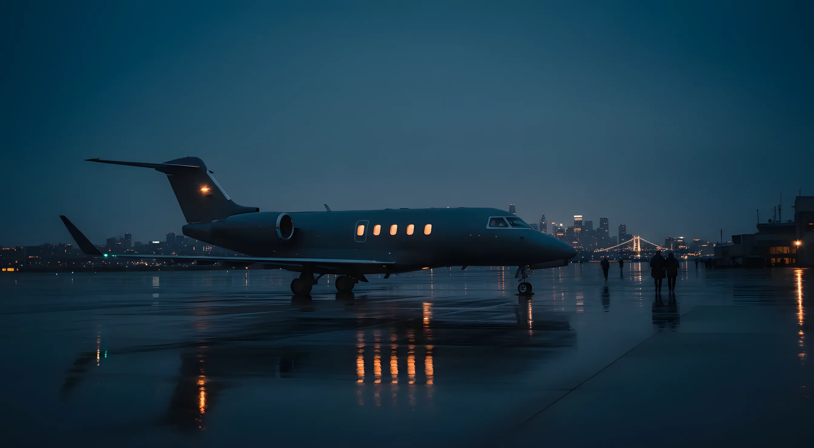 A private jet on an airport tarmac at dusk, with a city skyline in the distance.