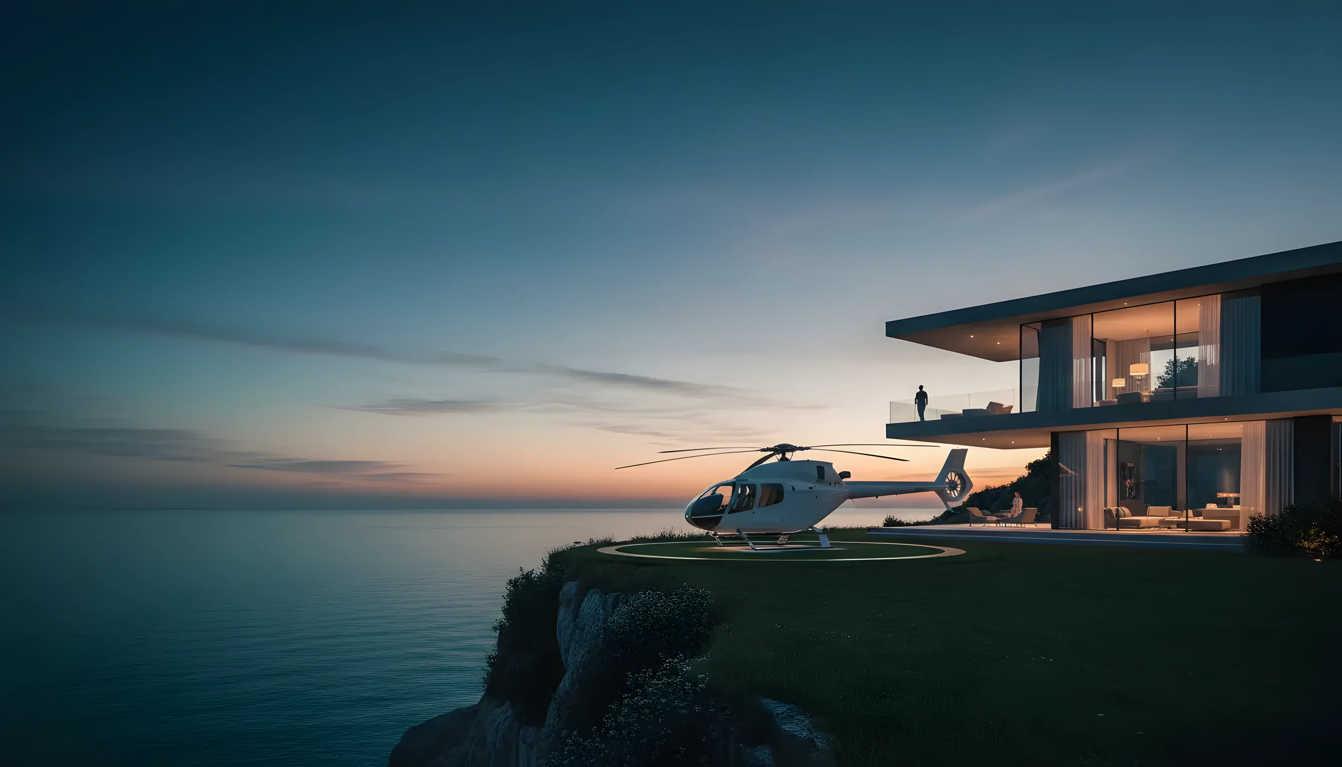 A white helicopter on a green helipad overlooking a calm turquoise ocean next to a luxury villa.