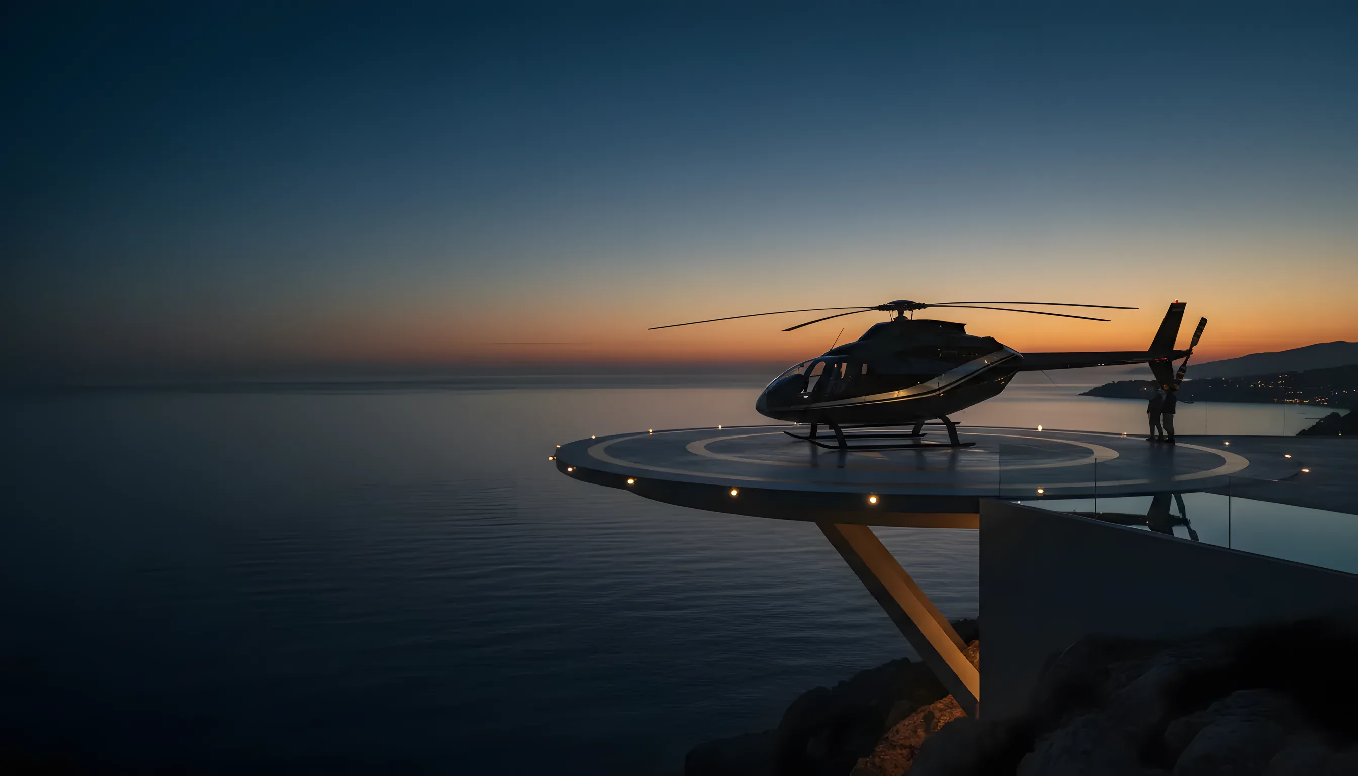 A helicopter on a helipad overlooking the Mediterranean Sea at sunrise.