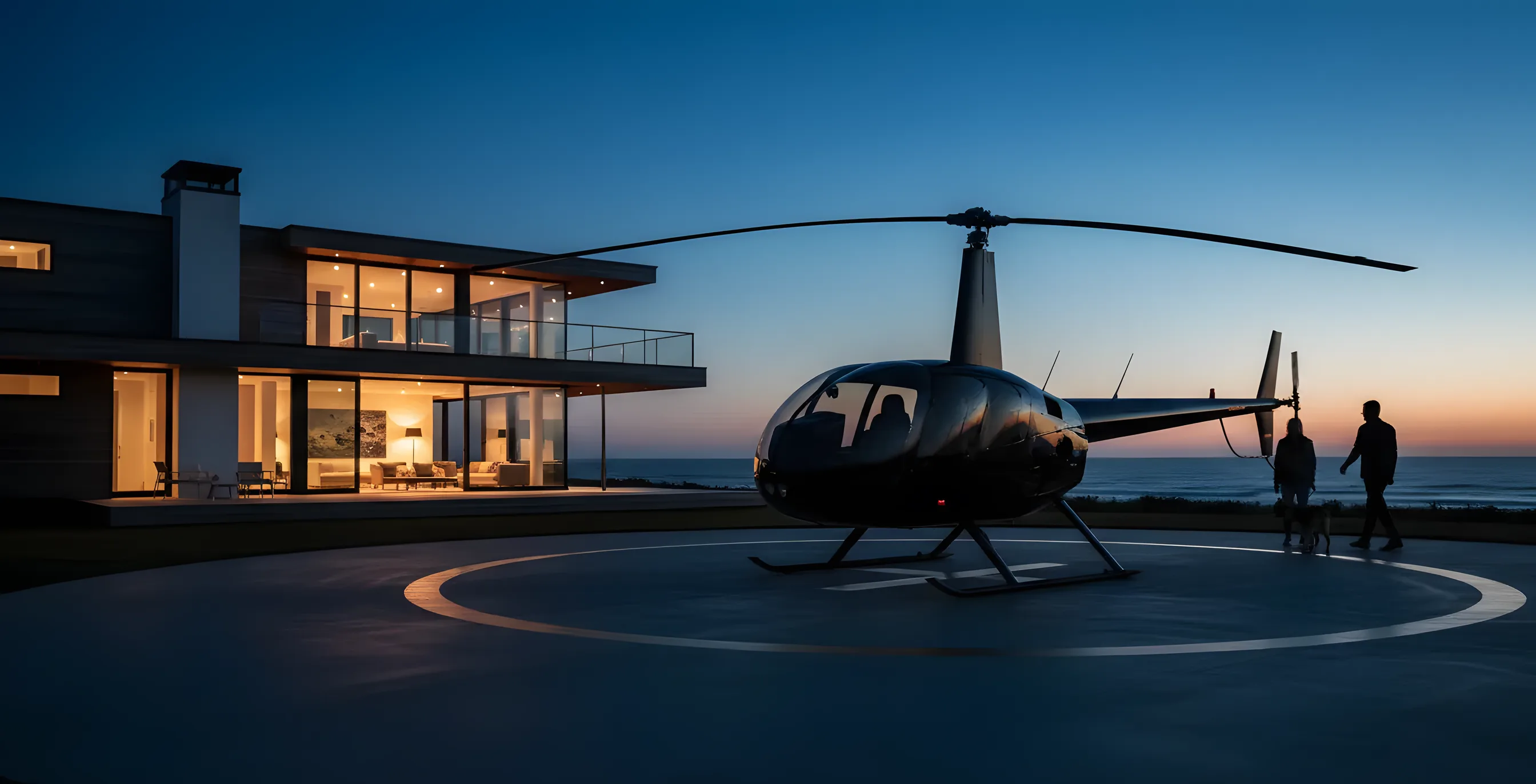 A person and their dog walk from a helicopter toward a modern beach house at dusk.