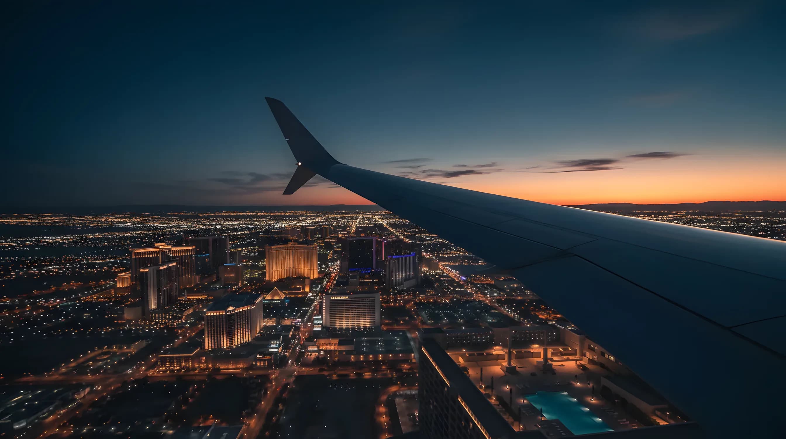 An aerial view of the Las Vegas Strip at twilight from the window of a private jet.