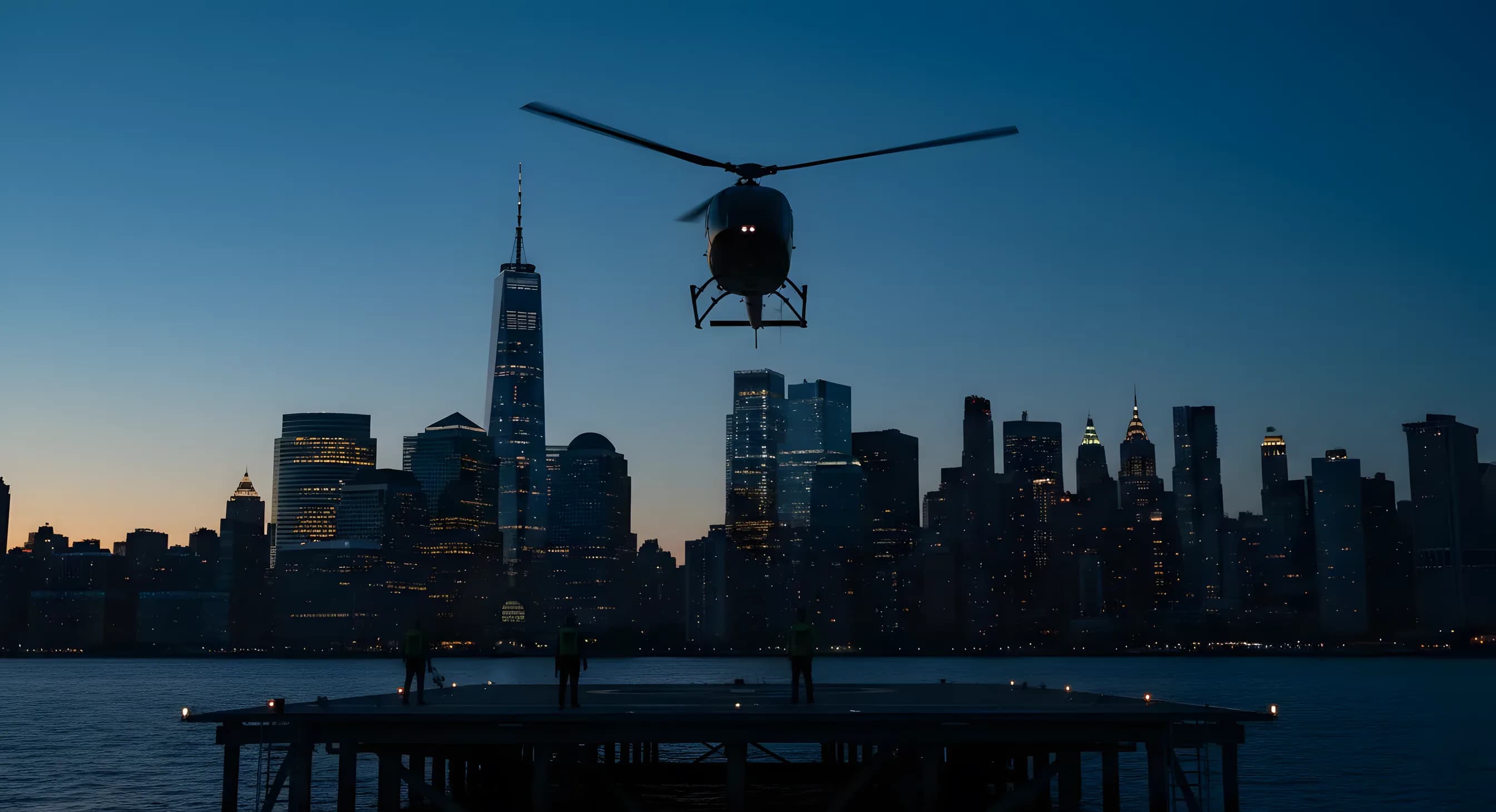 A helicopter takes off from a Manhattan heliport at dusk, with the city skyline in the background.