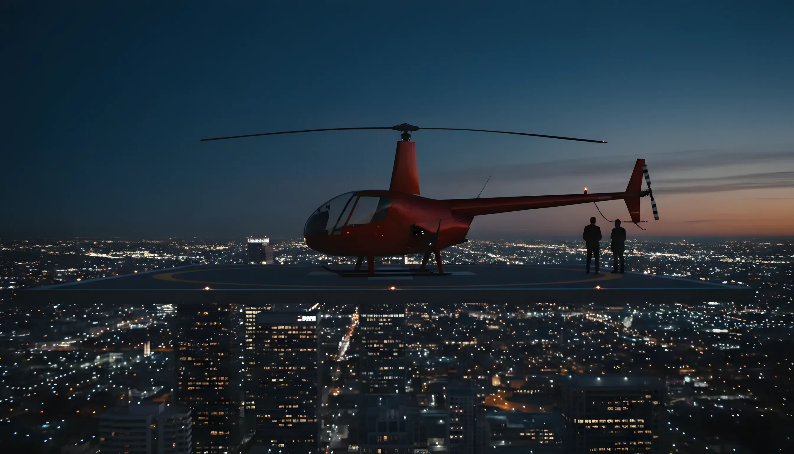 A red helicopter on a city rooftop helipad at dusk.