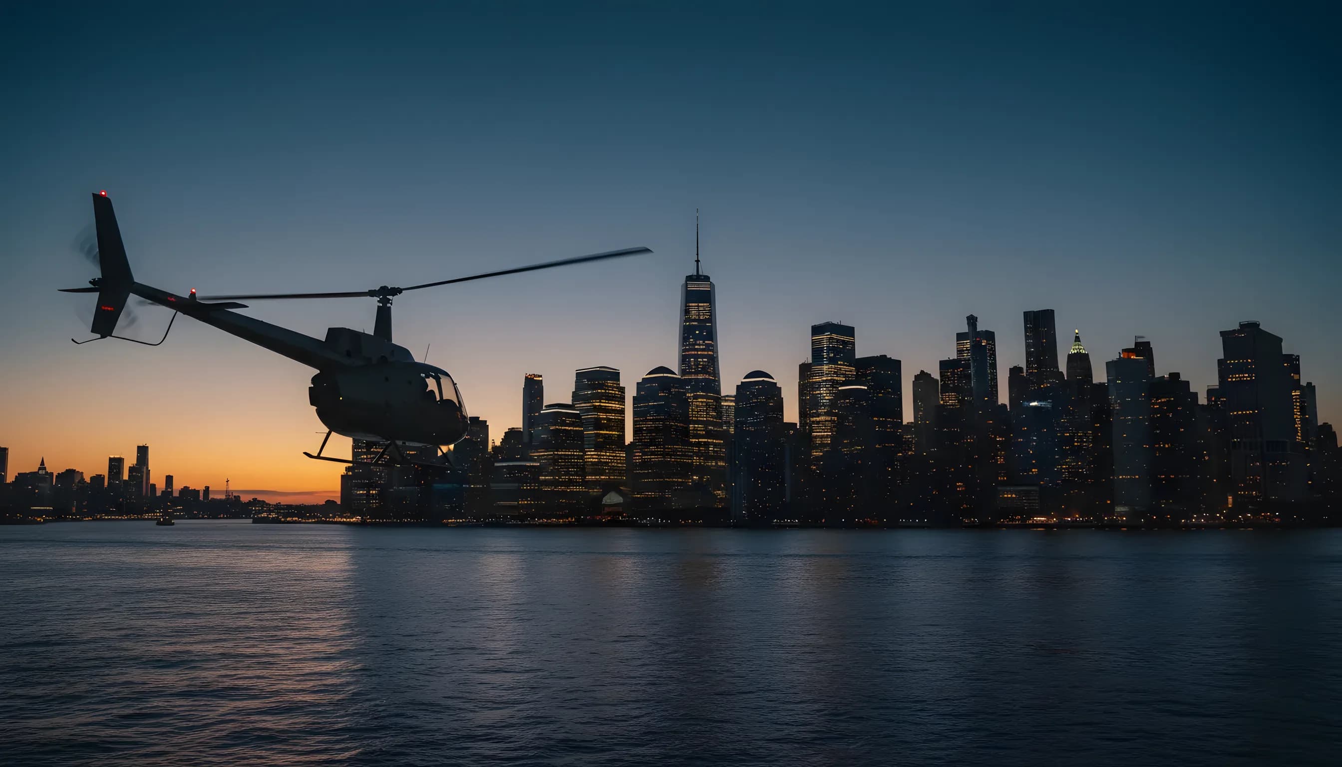 A helicopter flies over the illuminated Manhattan skyline at dusk.