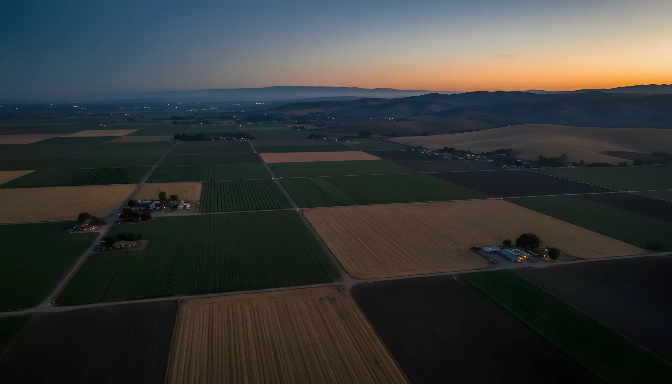 Aerial view of the patchwork agricultural fields of the Salinas Valley, California, from a private jet.
