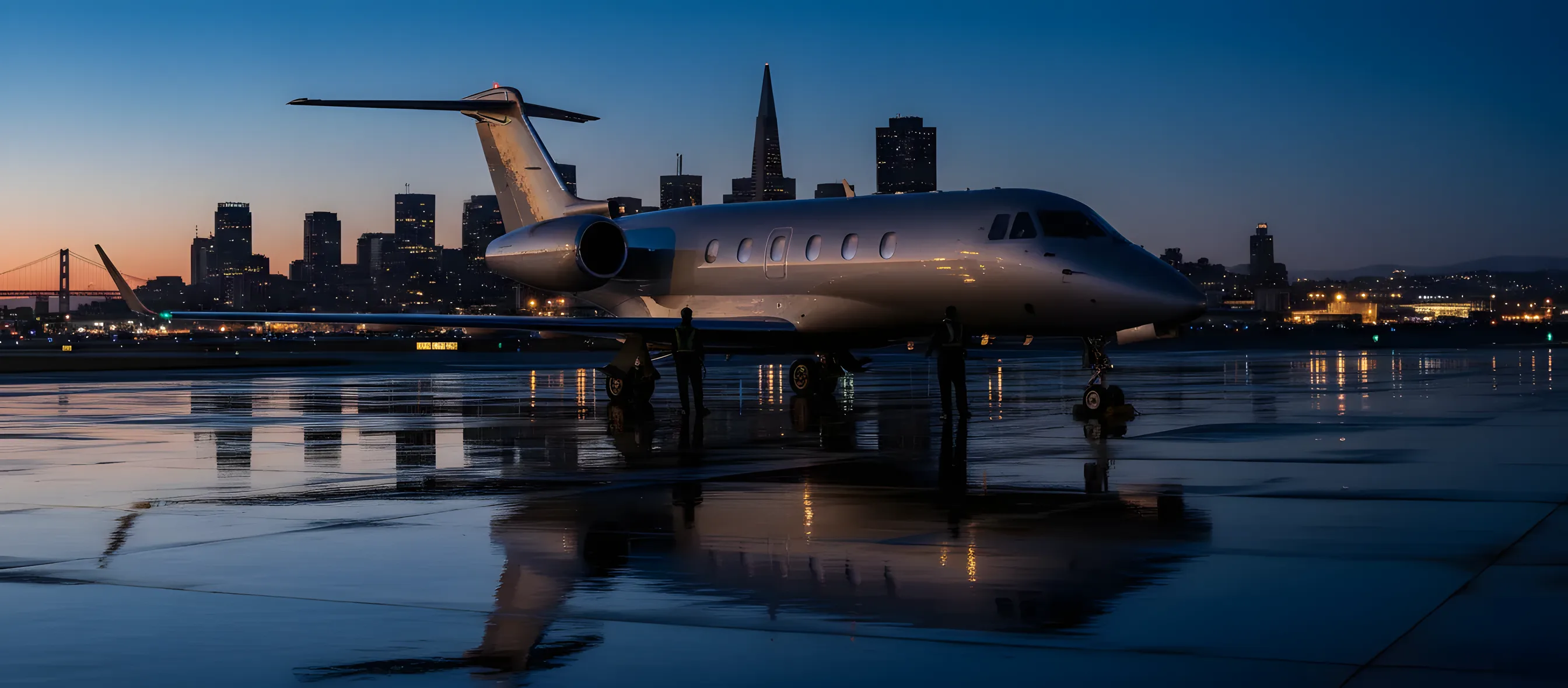 A private jet on an airfield at dusk, with the San Francisco skyline and Golden Gate Bridge in the background.
