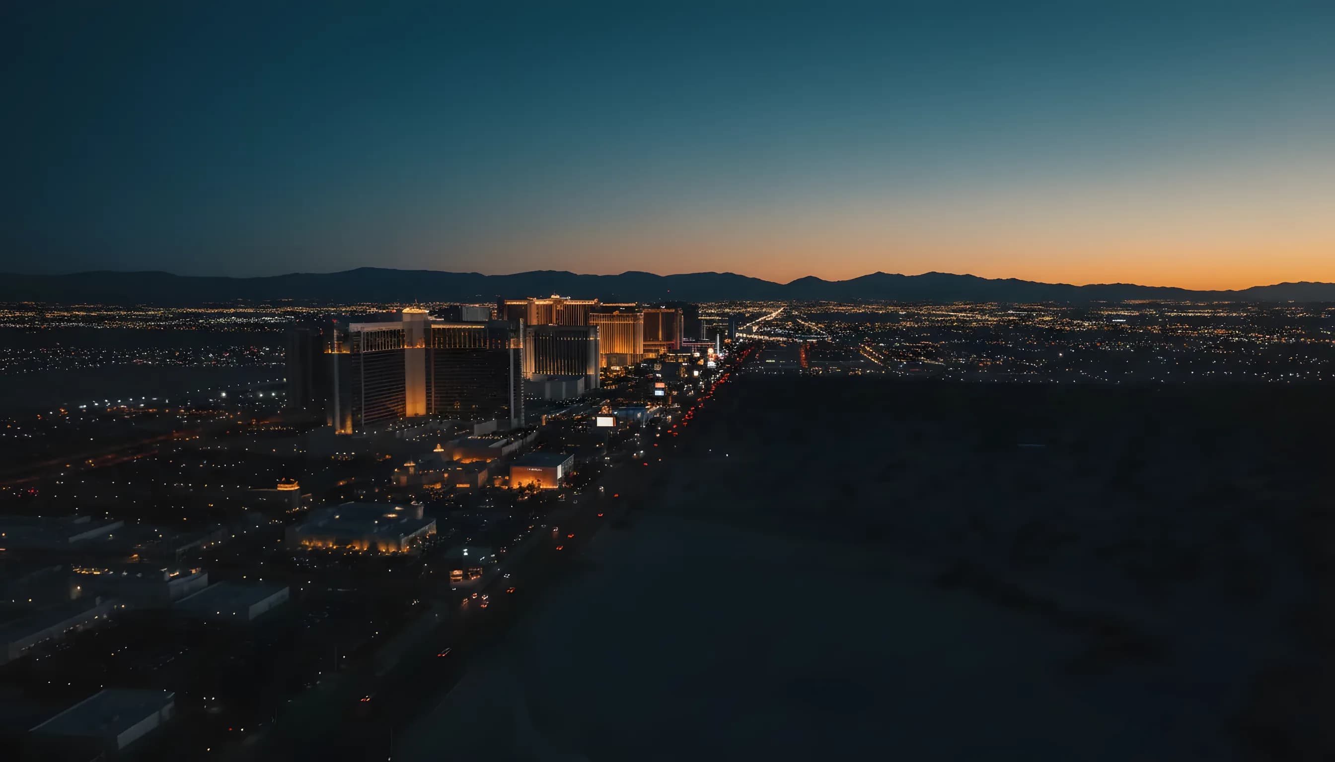 Aerial view of the Las Vegas Strip glowing at blue hour.