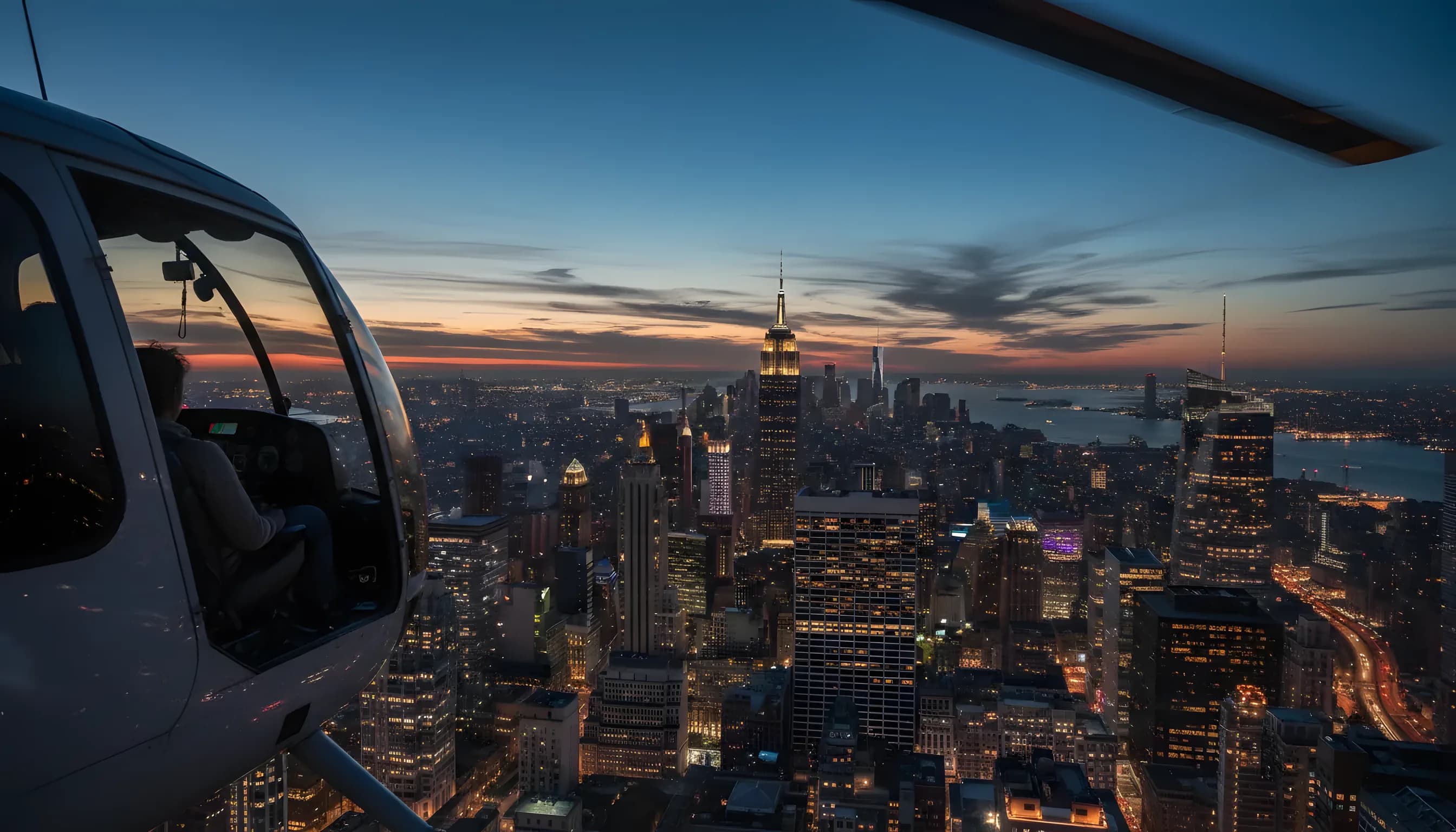 Aerial view of the Manhattan skyline at dusk from a helicopter.